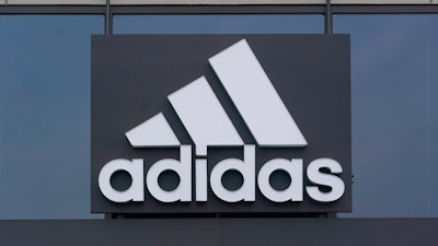 A sign is displayed in front of an Adidas retail store in Paramus, N.J., Tuesday, Oct. 25, 2022. Adidas has ended its partnership with the rapper formerly known as Kanye West over his offensive and antisemitic remarks, the latest company to cut ties with Ye and a decision that the German sportswear company said would hit its bottom line.