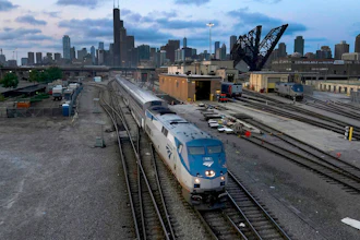 An Amtrak passenger train departs Chicago in the early evening headed south on Sept. 14, 2022, in Chicago. American consumers and nearly every industry will be affected if freight trains grind to a halt in December. Roughly half of all commuter rail systems rely at least in part on tracks that are owned by freight railroads, and nearly all of Amtrak’s long-distance trains run over the freight network.