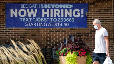 A hiring sign is displayed in Deerfield, Ill., Wednesday, Sept. 21, 2022. On Tuesday the Labor Department reports on job openings and labor turnover for September. U.S. job openings rose unexpectedly in September 2022, suggesting that the American labor market is not cooling as fast as the inflation fighters at the Federal Reserve hoped. Employers posted 10.7 million job vacancies in September, up from 10.2 million in August, the Labor Department said Tuesday. Economists had expected the number of job openings to drop below 10 million.