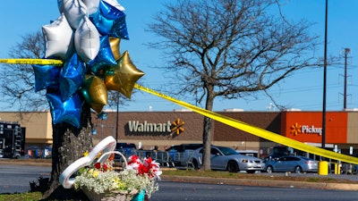 Flowers and balloons have been placed near the scene of a mass shooting at a Walmart, Wednesday, Nov. 23, 2022, in Chesapeake, Va. A Walmart manager opened fire on fellow employees in the break room of the Virginia store, killing several people in the country’s second high-profile mass shooting in four days, police and witnesses said Wednesday.