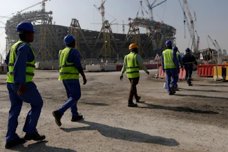 Workers walk to the Lusail Stadium, one of the 2022 World Cup stadiums, in Lusail, Qatar, Friday, Dec. 20, 2019.