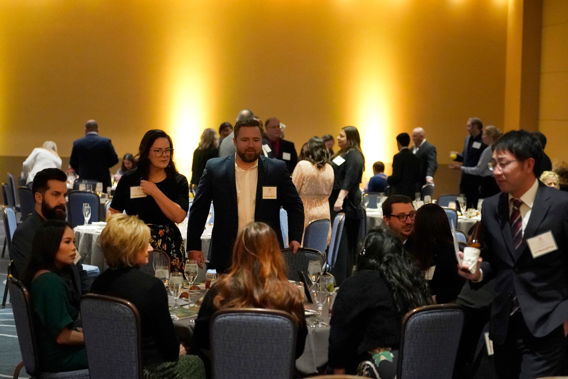 Employees and their guests attend the holiday dinner and karaoke party for Ajinomoto Health and Nutrition North America employees Friday, Dec. 9, 2022, in Schaumburg, Ill. Say goodbye to virtual wine tasting, and practice your karaoke. Company holiday parties are making a comeback. After more than two years of working in pajama bottoms and clinking glasses over Zoom, many office workers are yearning for a bit of glamour, or at least a sense of normalcy.
