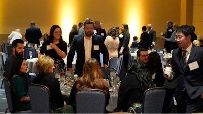 Employees and their guests attend the holiday dinner and karaoke party for Ajinomoto Health and Nutrition North America employees Friday, Dec. 9, 2022, in Schaumburg, Ill. Say goodbye to virtual wine tasting, and practice your karaoke. Company holiday parties are making a comeback. After more than two years of working in pajama bottoms and clinking glasses over Zoom, many office workers are yearning for a bit of glamour, or at least a sense of normalcy.