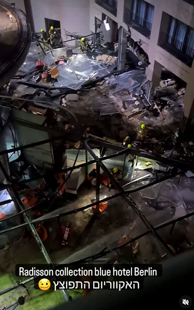 Following the burst of a huge aquarium, the atrium of a hotel is devastated in Berlin Germany, Friday, Dec. 16, 2022. German police say a huge aquarium in the center of Berlin has burst, causing a wave of devastation in and around the Sea Life tourist attraction. The words in Hebrew reads: 'The Aquarium exploded'.