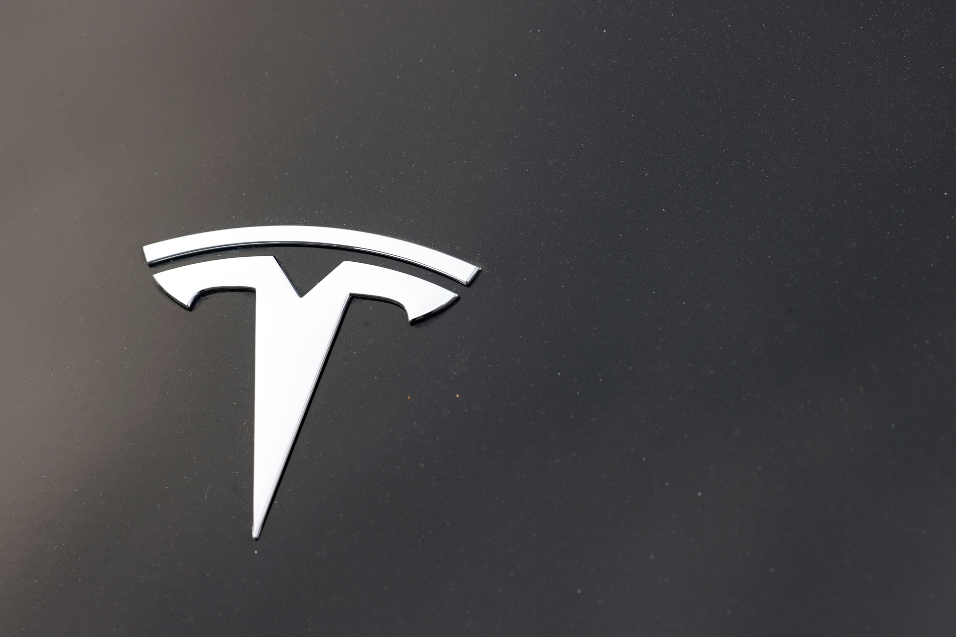 The Tesla company logo is seen on the hood of an unsold vehicle at a dealership, Aug. 9, 2020, in Littleton, Colo.