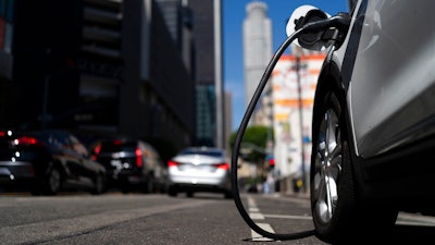 An electric vehicle is plugged into a charger in Los Angeles, on Aug. 25, 2022. People who want to buy an electric vehicle could get a bigger-than-expected tax credit come Jan. 1, 2023, because of a delay by the Treasury Department in drawing up rules for the tax breaks.