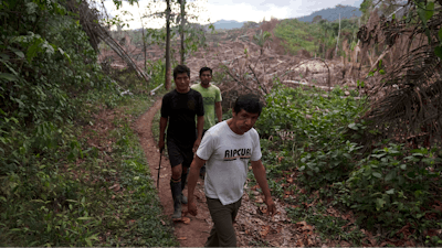 Residents of the Puerto Franco community walk near the limit of Cordillera Azul National Park in Peru's Amazon, Monday, Oct. 3, 2022.