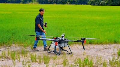 Operator introduces XAG P100 Agricultural Drone to rice farmers.