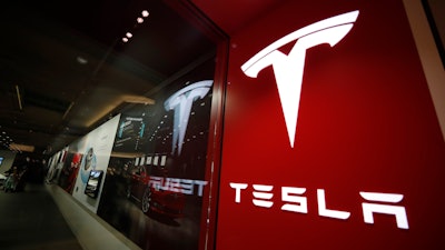 A sign bearing the company logo outside a Tesla store in Cherry Creek Mall in Denver is seen here on Feb. 9, 2019.