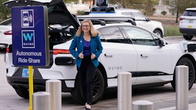 Phoenix Mayor Kate Gallego arrives in a self-driving vehicle, Friday, Dec. 16, 2022, at the Sky Harbor International Airport Sky Train facility in Phoenix.