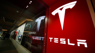 The Tesla logo is seen at the company's store in Denver's Cherry Creek Mall on Feb. 9, 2019. Shares of Tesla tumbled Tuesday, Jan. 3, 2023, on the first full day of trading since the company announced 2022 delivery numbers that fell short of targets.