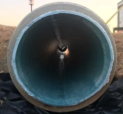 The blue cured-in-place pipe, or CIPP, can be seen inside this damaged storm sewer pipe. The CIPP was created by steam cooking the resin into the hard plastic.