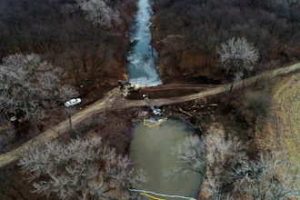 In this photo taken by a drone, cleanup continues in the area where the ruptured Keystone pipeline dumped oil into a creek in Washington County, Kan., Dec. 9, 2022.