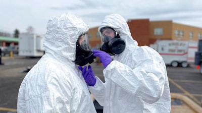 This photo provided by the Ohio National Guard, ONG 52nd Civil Support Team members prepare to enter an incident area to assess remaining hazards with a lightweight inflatable decontamination system (LIDS) in East Palestine, Ohio, Tuesday, Feb. 7, 2023. Authorities say air monitoring hasn’t detected dangerous levels of fumes in communities where crews released and burned toxic chemicals from a derailed train. But they said Tuesday that Ohio and Pennsylvania residents living close to the wreckage still aren’t being allowed in their homes.