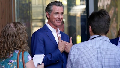 California Gov. Gavin Newsom speaks with reporters said on Friday, Oct. 7, 2022, in Sacramento. California lawmakers are having their first public hearing on a proposal to penalize some oil company profits. Newsom proposed the law in response to record high gas prices over the summer.