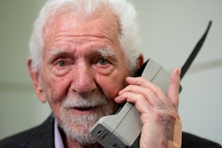 Marty Cooper, the inventor of first commercial mobile phone, poses for the press with a Motorola DynaTAC 8000x, during an interview with The Associated Press at the Mobile World Congress 2023 in Barcelona, Spain, Monday, Feb. 27, 2023. The four-day show kicks off Monday in a vast Barcelona conference center. It's the world's biggest and most influential meeting for the mobile tech industry.