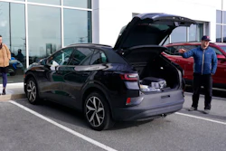 A couple shops for a Volkswagen ID.4 electric vehicle while assisted by a salesman at right, at a new car dealership, Monday, Feb. 6, 2023, in Manchester, N.H. On Wednesday the Commerce Department releases U.S. retail sales data for January.