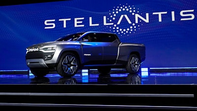 The Ram 1500 Revolution electric battery powered pickup truck is displayed on stage during the Stellantis keynote at the CES tech show on Jan. 5, 2023, in Las Vegas. Automaker Stellantis has reported its earnings grew in 2022 from a year earlier as it pressed an industrywide strategy to shift into electric vehicles, leading to a jump in sales. The company said Wednesday, Feb. 22, 2023, that net revenue of 179.6 billion euros was up 18% from 2021. It reported net profit of 16.8 billion, up 26% from 2021.