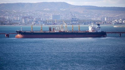 An oil tanker is moored at the Sheskharis complex, part of Chernomortransneft JSC, a subsidiary of Transneft PJSC, in Novorossiysk, Russia, on Oct. 11, 2022. A Russian official says the country will will cut oil production by 500,000 barrels per day next month in response to the West capping the price of its crude over the war in Ukraine. According to multiple Russian news media reports, Deputy Prime Minister Alexander Novak said Friday, Feb. 10, 2023 that “we will not sell oil to those who directly or indirectly adhere to the ’price ceiling.''