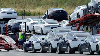 Tesla cars are loaded onto carriers at the Tesla electric car plant on May 13, 2020, in Fremont, Calif. Tesla is recalling nearly 363,000 vehicles with its “Full Self-Driving” system to fix problems with the way it behaves around intersections and following posted speed limits, the National Highway Traffic Safety Administration announced Thursday, Feb. 16, 2023.