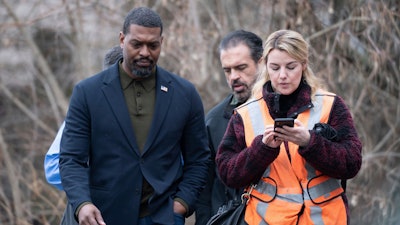 Environmental Protection Agency Administrator Michael Regan left, walks with his staff through East Palestine, Ohio on Thursday, Feb. 16, 2023.