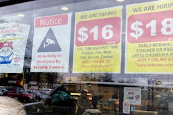Hiring signs displayed at a grocery store in Arlington Heights, Ill., Jan. 13, 2023.