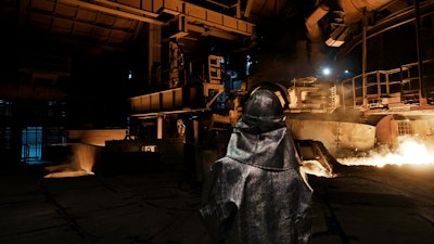 A worker stands inside a blast furnace at the Zaporizhstal steel plant, in Zaporizhia, Ukraine, Wednesday, March 1, 2023.
