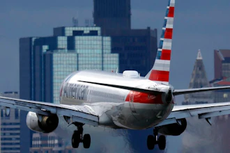 An American Airlines plane lands at Logan International Airport, Thursday, Jan. 26, 2023, in Boston. Communities around the world emitted more carbon dioxide than any other year on record in 2022 as air travel rebounded from the pandemic and cities turned to coal to provide a cheap source of power.