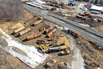 A view of the scene Friday, Feb. 24, 2023, as the cleanup continues at the site of a Norfolk Southern freight train derailment that happened on Feb. 3, in East Palestine, Ohio. On Tuesday, Feb. 28, in the wake of a fiery Ohio derailment and other recent crashes, federal regulators urged that freight railroads should reexamine the way they use and maintain the detectors along the tracks that are supposed to spot overheating bearings.
