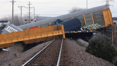 Multiple cars of a Norfolk Southern train lie toppled after derailing at a train crossing with Ohio 41 in Clark County, Ohio, Saturday, March 4, 2023.