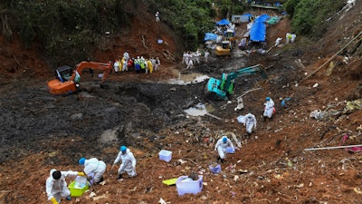 In this photo released by Xinhua News Agency, search and rescuer workers conduct search operations at the China Eastern flight crash site in Tengxian County on March 26, 2022, in southern China's Guangxi Zhuang Autonomous Region.