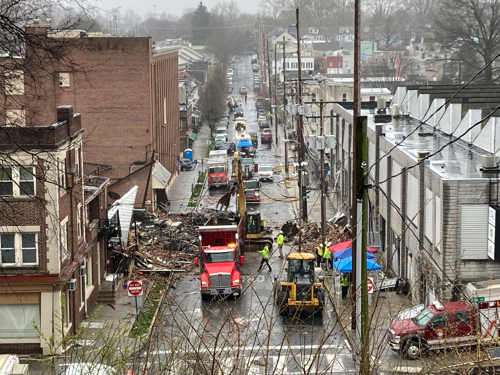Emergency responders and heavy equipment at the site of a deadly explosion at a chocolate factory in West Reading, Pennsylvania, March 25, 2023.