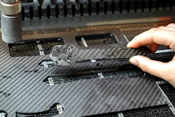 Desktop waterjet cutter creating parts out of carbon fiber.