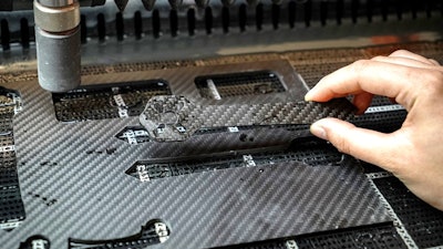 Desktop waterjet cutter creating parts out of carbon fiber.