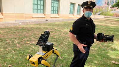 Honolulu Police Acting Lt. Joseph O'Neal demonstrates a robotic dog in Honolulu, Friday May 14, 2021. New York City officials unveiled three new high-tech policing devices Tuesday, including a similar robotic dog that critics called creepy when it first joined the police pack 2 1/2 years ago.