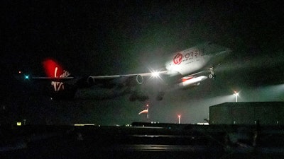 A repurposed Virgin Atlantic Boeing 747 aircraft, named Cosmic Girl, carrying Virgin Orbit's LauncherOne rocket, takes off from Spaceport Cornwall at Cornwall Airport, Newquay, England, on Jan. 9, 2023. Virgin Orbit said Thursday March 16, 2023 it is pausing all operations amid reports that the company is furloughing almost all its staff as part of a bid to seek a funding lifeline.