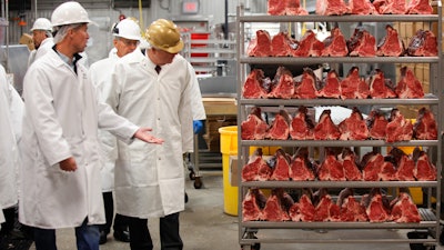 U.S. Agriculture Secretary Tom Vilsack, center, tours the Greater Omaha Packing beef processing plant in Omaha, Neb., on Nov. 2, 2022.