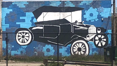 A mural of a Ford Model T on the wall of a commercial building in Highland Park, Mich., is seen on May 9, 2023.
