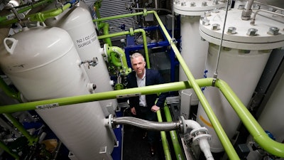 Brian Asparro, chief operating officer of CarbonQuest, stands in a production room where liquid carbon dioxide is converted from a byproduct of a natural gas fired water boiler to a salable industrial product, Tuesday, April 18, 2023, in New York.