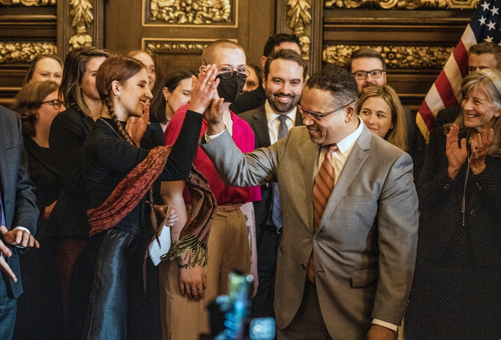 Attorney General Keith Ellison gives a high five to Katy Johnson, who was once addicted to vaping in St. Paul, Minn., on Wednesday, May 17, 2023.