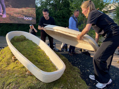 Director Lonneke Westhoff, right, and founder Bob Hendrikx, left, of Dutch startup Loop Biotech display one of the cocoon-like coffins, grown from local mushrooms and up-cycled hemp fibres, designed to dissolve into the environment amid growing demand for more sustainable burial practices, in Delft, Netherlands, Monday, May 22, 2023.