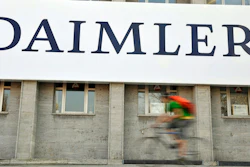 A cyclist passes a logo of German car company Daimler in Berlin on April 8, 2009. German truck maker Daimler, Japan’s top automaker Toyota and two other automakers said Tuesday, May 30, 2023, they will work together on new technologies, including use of hydrogen fuel, to help fight climate change.