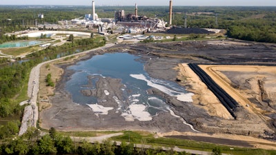 The Richmond city skyline can be seen on the horizon behind the coal ash ponds along the James River near Dominion Energy's Chesterfield Power Station in Chester, Va., Tuesday, May 1, 2018.