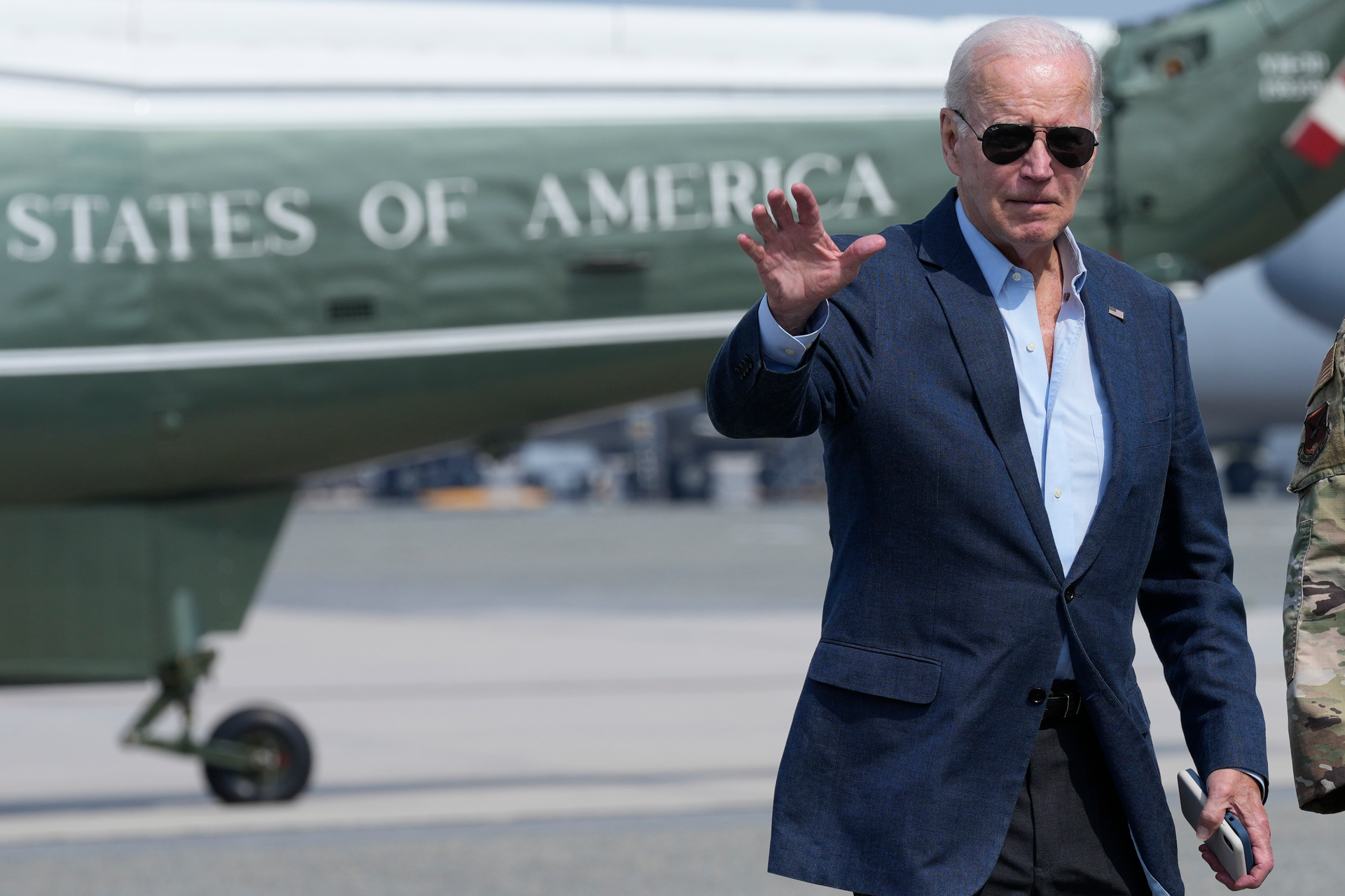 President Joe Biden waves as he walks to board Air Force One at Dover Air Force Base, Del., Monday, June 19, 2023, as he heads to California.