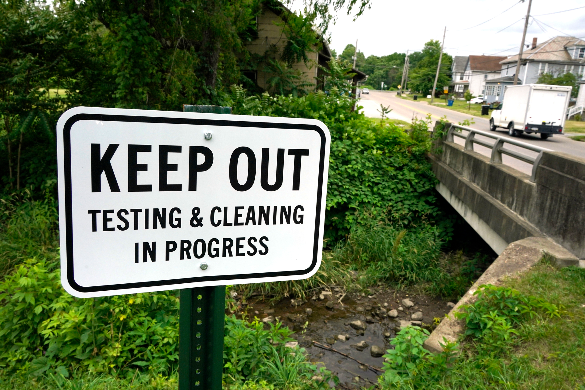 A warning sign is posted near a stream in East Palestine Park in East Palestine, Ohio on Thursday, June 22, 2023.