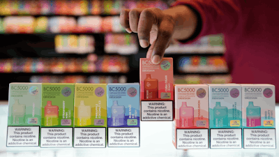 An employee displays some of the varieties of disposable electronic cigarette devices manufactured by EB Design, formerly known as Elf Bar, at Vapes N Smoke in Pinecrest, Fla., Monday, June 26, 2023.