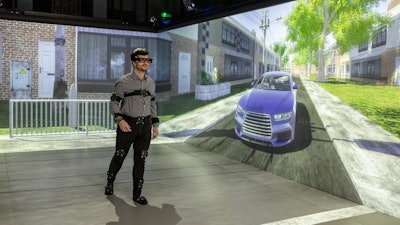 Participant interacting as a pedestrian in a driver-pedestrian simulator.