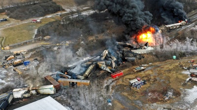 In this photo taken with a drone, portions of a Norfolk Southern freight train that derailed the previous night in East Palestine, Ohio, remain on fire at mid-day, Feb. 4, 2023. The Pipelines and Hazardous Materials Safety Administration proposed a new rule Wednesday, June 21, that would require all railroads to quickly provide the details of everything aboard their trains electronically to every emergency responder within 10 miles of a derailment.