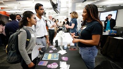 Georgia State University students Kavita Javalagi, left, and Gana Natarajan, second from left, speak with Shetundra Pinkston, during the Startup Student Connection job fair, Wednesday, March 29, 2023, in Atlanta. For the thousands of workers who'd never experienced upheaval in the tech sector, the recent mass layoffs at companies like Google, Microsoft, Amazon and Meta came as a shock. Now they are being courted by long-established employers whose names aren't typically synonymous with tech work, including hotel chains, retailers, investment firms, railroad companies and even the Internal Revenue Service.