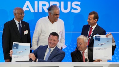 CEO of IndiGo Pieter Elbers, bottom left, Airbus Chief Commercial Officer and Head of International Christian Scherer, borrom right, Chairman and Non-Executive Independent Director of IndiGo Dr. Venkataramani Sumantran, left, Promoter & Managing Director of IndiGo Rahul Bhatia, centre, and Airbus CEO Guillaume Faury pose for a picture with signed documents during a news conference during the Paris Air Show in Le Bourget, north of Paris, France, Monday, June 19, 2023.